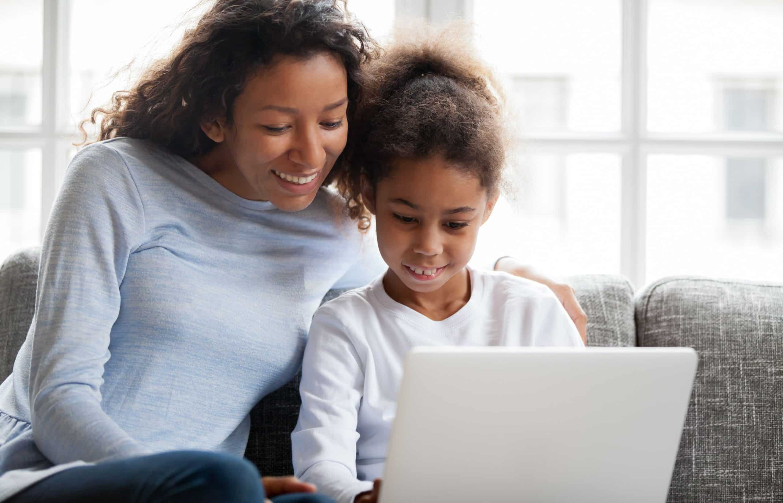 Woman and daughter looking at school website